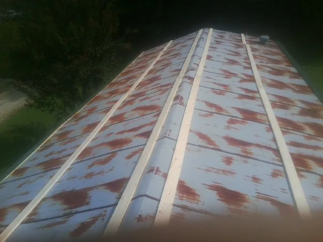 Rusted metal roof panels with new wood purlins before replacement — Storm Damage Roof Repair in Wytheville by Roofing Brothers