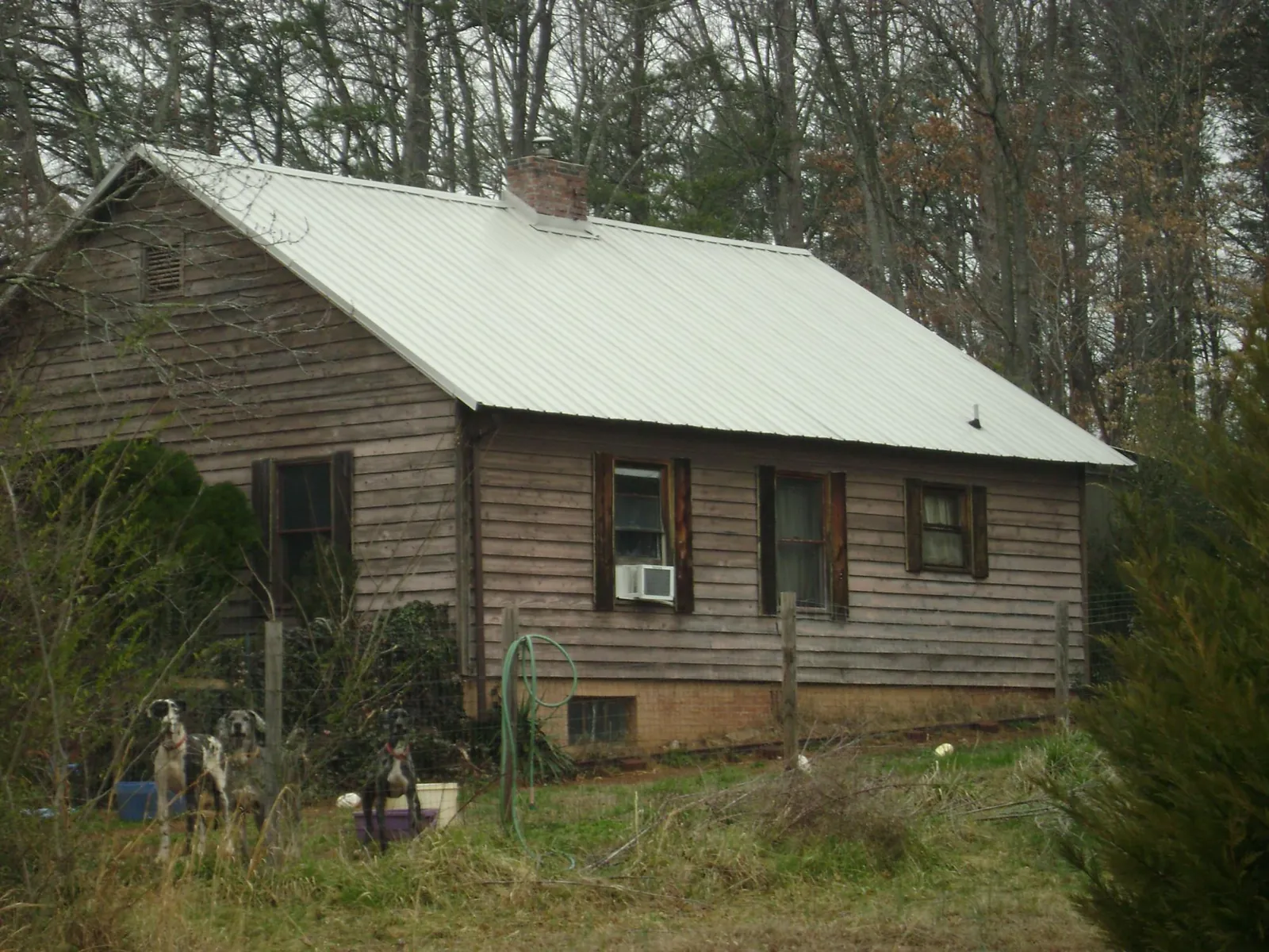 White metal roof on an old wood sided farmhouse, from a Metal Roof Installation job in Wytheville